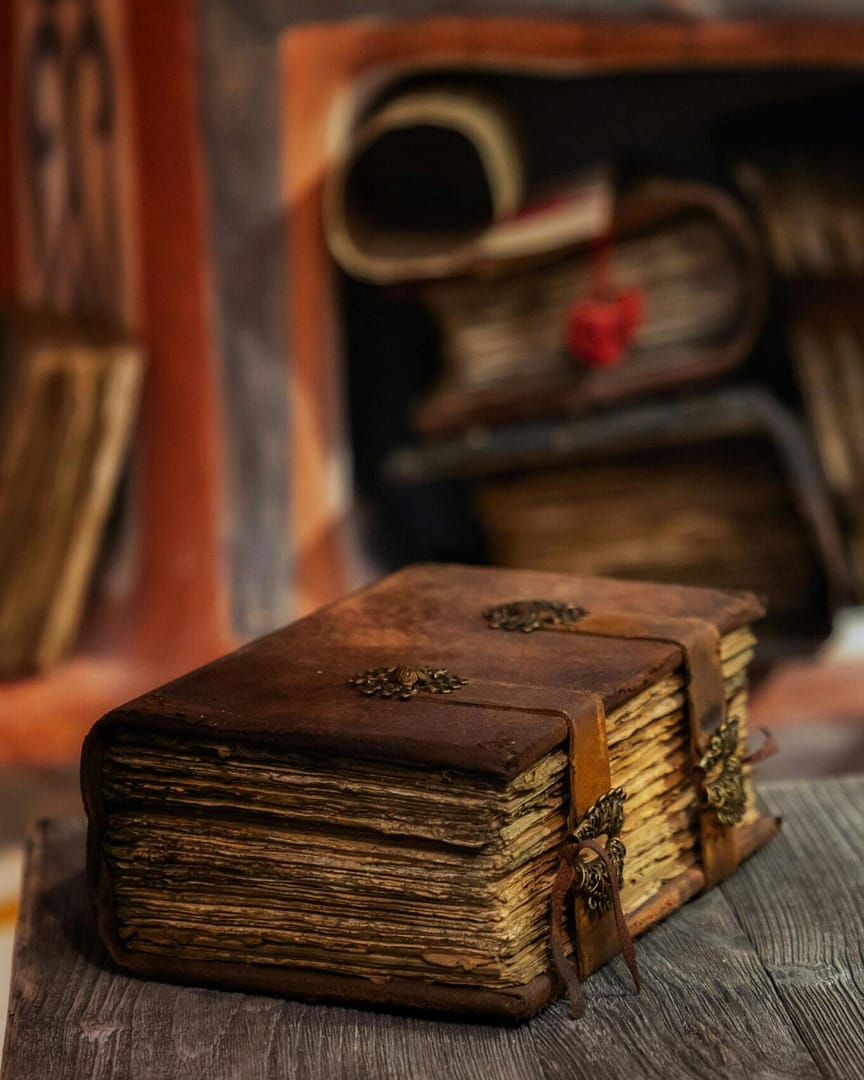 Brown book on wooden table